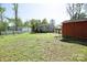 Expansive backyard showing a wooden deck, a shed, and ample green space at 6124 Old Plank Rd, Charlotte, NC 28216