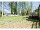 Spacious backyard featuring a patio, a wooden deck, and a white fence at 6124 Old Plank Rd, Charlotte, NC 28216