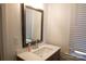 Bathroom vanity features a new sink, bright lighting, and a large mirror, next to a window at 6124 Old Plank Rd, Charlotte, NC 28216