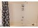 Bathroom showcasing a bathtub with shower and patterned curtain at 6124 Old Plank Rd, Charlotte, NC 28216