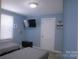 Relaxing bedroom featuring two twin beds, a modern TV, and plenty of space for comfort and leisure at 6124 Old Plank Rd, Charlotte, NC 28216