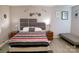 Comfortable bedroom featuring a bed with a striped comforter, nightstands, and decorative wall art at 6124 Old Plank Rd, Charlotte, NC 28216