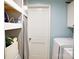 Laundry room showing the included washer, dryer, and storage shelves at 6124 Old Plank Rd, Charlotte, NC 28216
