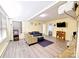 Comfortable living room featuring new flooring, fireplace, modern furniture, and a gaming console at 6124 Old Plank Rd, Charlotte, NC 28216