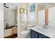 Well-lit bathroom features white-tiled floors, a blue vanity, and access to a connected room at 6165 Caseys Side Way, Fort Mill, SC 29708