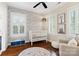 Charming Bedroom features designer wallpaper, hardwood floors, a white crib, and lots of natural light at 6165 Caseys Side Way, Fort Mill, SC 29708
