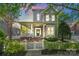 Charming two-story home with gray siding, a front porch, a picket fence, and mature landscaping at 6165 Caseys Side Way, Fort Mill, SC 29708
