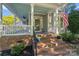 Inviting front porch with brick steps, swing, and an American flag display at 6165 Caseys Side Way, Fort Mill, SC 29708