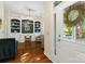 Cozy home office featuring built-in shelving, hardwood floors, and a view of the front yard at 6165 Caseys Side Way, Fort Mill, SC 29708