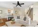 Cozy living room with white sofa, hardwood floors, and view into the kitchen at 6165 Caseys Side Way, Fort Mill, SC 29708