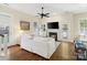Bright living room with hardwood floors, a fireplace, and white furnishings and trim at 6165 Caseys Side Way, Fort Mill, SC 29708