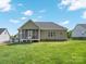 Large backyard showcasing a screened porch, green lawn, and privacy fencing at 621 Summey Farm Dr, Dallas, NC 28034