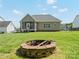 Beautiful backyard with a brick fire pit, green grass, screened in porch, and a home at 621 Summey Farm Dr, Dallas, NC 28034