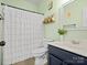 Charming bathroom with mint green walls, ruffled shower curtain, and modern vanity at 621 Summey Farm Dr, Dallas, NC 28034