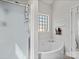 Bright bathroom features corner tub, glass-enclosed shower, and neutral finishes at 621 Summey Farm Dr, Dallas, NC 28034