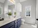 Bright bathroom features double sinks, modern vanity, and ample natural light at 621 Summey Farm Dr, Dallas, NC 28034