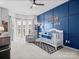 Bright Bedroom features a crib, chair, and blue accent wall by a window bay at 621 Summey Farm Dr, Dallas, NC 28034