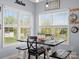 Bright breakfast nook featuring a farmhouse table, bench seating, and ample natural light from large windows at 621 Summey Farm Dr, Dallas, NC 28034