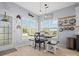 Charming dining area with rustic table, bench seating, and large windows offering a bright, inviting space at 621 Summey Farm Dr, Dallas, NC 28034