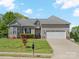 Charming single Gathering home with well-manicured lawn, two-car garage, and inviting curb appeal at 621 Summey Farm Dr, Dallas, NC 28034