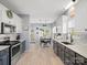 Open-concept kitchen boasts stainless appliances, stylish cabinetry, and adjacent dining area with backyard view at 621 Summey Farm Dr, Dallas, NC 28034