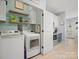 Convenient laundry area off kitchen features modern washer/dryer and functional shelving at 621 Summey Farm Dr, Dallas, NC 28034