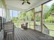 Relaxing screened porch with outdoor seating overlooking the green backyard at 621 Summey Farm Dr, Dallas, NC 28034