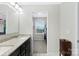 This primary bathroom features a granite-topped vanity, with a walk-in closet at 6563 Kinder Ln, Lancaster, SC 29720