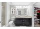 Well-lit bathroom features a double sink vanity with granite countertops and a separate shower at 6563 Kinder Ln, Lancaster, SC 29720