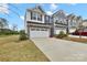 Charming two-story home featuring a stone facade, attached two-car garage, and a well-manicured lawn at 6563 Kinder Ln, Lancaster, SC 29720