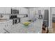 Bright kitchen boasts stainless steel appliances, granite countertops, and a center island at 6563 Kinder Ln, Lancaster, SC 29720