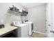 Functional laundry room featuring a washer, dryer, and overhead storage at 6563 Kinder Ln, Lancaster, SC 29720