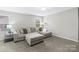 Relaxing loft space with sectional sofa, large ottoman, and great natural light ideal for unwinding and entertaining at 6563 Kinder Ln, Lancaster, SC 29720