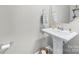 Stylish powder room with pedestal sink, elegant fixtures, and a modern mirror creating an inviting space at 6563 Kinder Ln, Lancaster, SC 29720