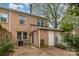 Brick patio with flowers, access to a storage shed and back door entrance to townhome at 6801 Dumbarton Dr, Charlotte, NC 28210