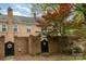 Townhome with a brick fence and an ornate black gate leading into the back yard at 6801 Dumbarton Dr, Charlotte, NC 28210