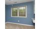 Blue bedroom featuring hardwood floors, a window providing natural light, and a built-in desk at 6801 Dumbarton Dr, Charlotte, NC 28210