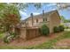 Brick townhome exterior featuring well-manicured landscaping and mulch at 6801 Dumbarton Dr, Charlotte, NC 28210