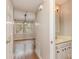 Hallway leading to a bedroom with hardwood floors, next to a half bathroom with a marble countertop at 6801 Dumbarton Dr, Charlotte, NC 28210