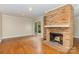 Spacious living room featuring a brick fireplace, hardwood flooring, and sliding glass doors to the outdoors at 6801 Dumbarton Dr, Charlotte, NC 28210