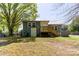 Spacious backyard with mature trees, back porch, and a partially fenced yard at 702 Hazel Ave, Kannapolis, NC 28083