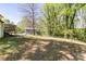 Large grassy backyard with mature trees and partial view of back of the house at 702 Hazel Ave, Kannapolis, NC 28083