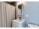 Modern bathroom featuring a stylish vanity, decorative mirror and a tiled shower with a shower curtain at 702 Hazel Ave, Kannapolis, NC 28083