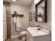 Bathroom featuring modern vanity, stylish mirror, neutral paint and mosaic-accented shower at 702 Hazel Ave, Kannapolis, NC 28083