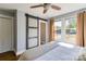 Comfortable bedroom with a sliding barn door, hardwood floors, neutral paint and a large window at 702 Hazel Ave, Kannapolis, NC 28083