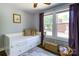 Charming bedroom with ample natural light, hardwood floors, and a cozy daybed with drawers at 702 Hazel Ave, Kannapolis, NC 28083