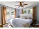 Inviting bedroom featuring hardwood floors, ceiling fan and multiple windows offering natural light at 702 Hazel Ave, Kannapolis, NC 28083