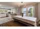 Dining area with an adjoining kitchen, large windows, and bench seating at 702 Hazel Ave, Kannapolis, NC 28083