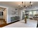 Charming dining room featuring stylish chandelier, decorative shelving and convenient open access to the modern kitchen at 702 Hazel Ave, Kannapolis, NC 28083