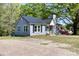 Charming single-story home with well-maintained lawn, American flag, and mature tree at 702 Hazel Ave, Kannapolis, NC 28083